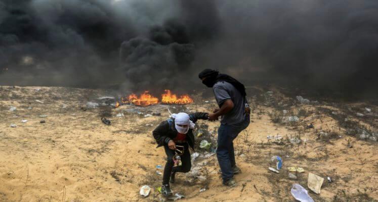 Gazans burning tyres while attempting to breach Israel's border and attack Israelis 