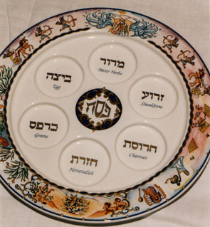 Seder dish, with places for the items and Passover motifs.